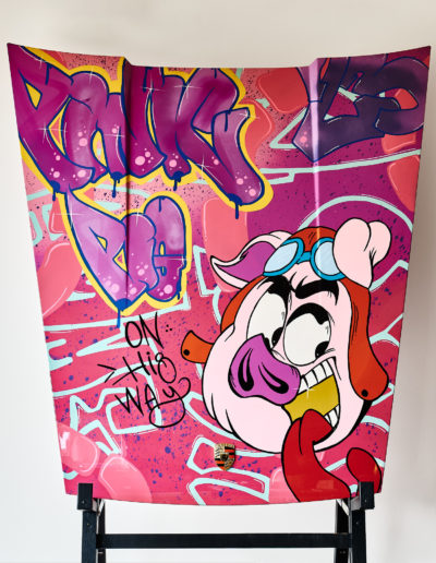 Hood with a cartoon pig painted on it